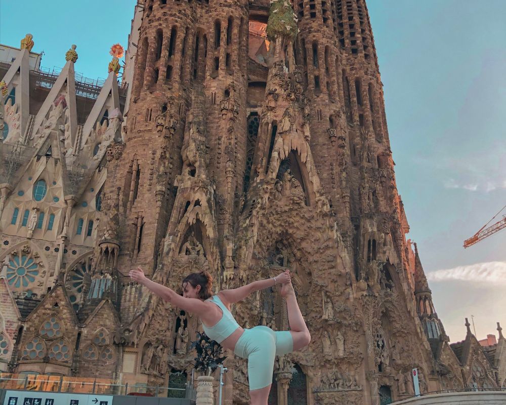 yoga pose in front of sagrada familia barcelona